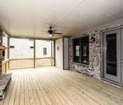 Outdoor Deck with Brick Fireplace in The Aragon built by Waterford Homes in Sandy Springs